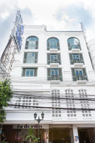 a white building with chinese writing on it at Lucky House Khaosan in Bangkok