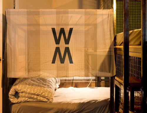 a bed with a sign that says w on it at Wontonmeen in Hong Kong