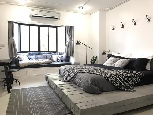 a bedroom with a bed and a couch in a room at Stay in Style at Nimman R208 in Chiang Mai