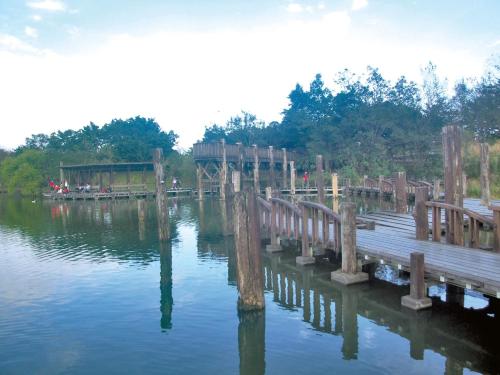 a wooden bridge over a body of water at Bei Yue B&B in Luodong