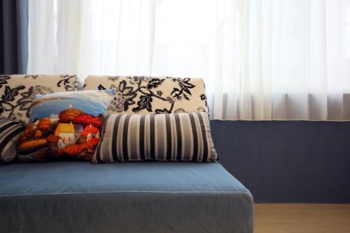 a blue couch with a pillow on top of it at Bei Yue B&B in Luodong