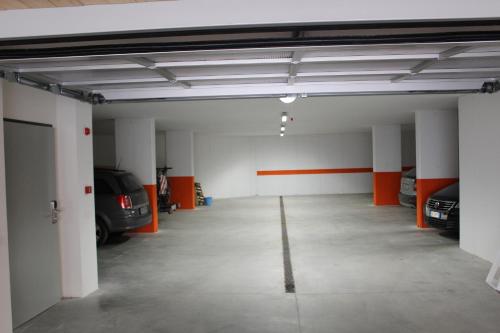 an empty garage with two cars parked in it at Alpin Relais B&B Villa Melisse in Colfosco