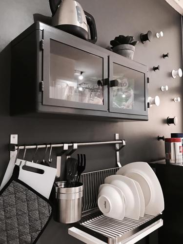 a kitchen with a utensil rack and a microwave at Stay in Style at Nimman R208 in Chiang Mai