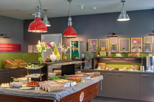 a bakery with a buffet of food on a counter at MEININGER Hotel Berlin Alexanderplatz in Berlin