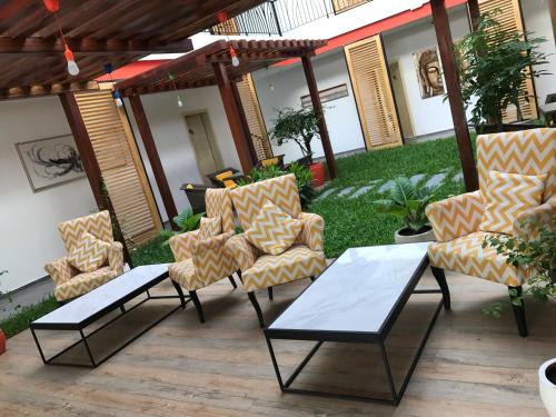 a patio with two chairs and a coffee table at Benny's City Hotel in Sihanoukville