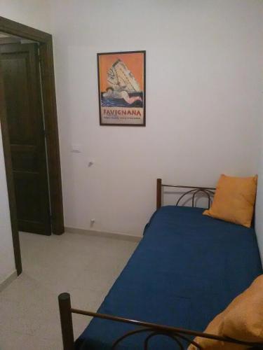 a bedroom with a bed and a picture on the wall at Residence Marsala Antica in Marsala
