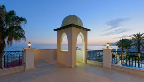 a gazebo on a balcony overlooking the ocean at Alaaddin Beach Hotel - Adult Only in Alanya
