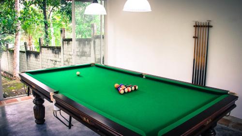 a pool table with balls in a room at Airport Green Olive Villa in Katunayaka