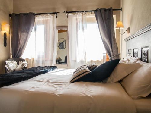 a large white bed in a room with a window at Alice Relais Nelle Vigne in Vittorio Veneto