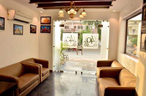 a waiting room with two couches and a window at Hotel 49 in Amritsar