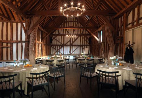 a dining room with tables and chairs in a barn at The Olde Bell, BW Signature Collection in Marlow