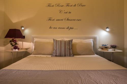 a bedroom with a bed with a quote on the wall at Fior di Loto Sweetness in Cagliari