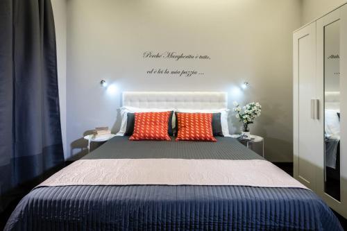 a bedroom with a large bed with two pillows at Fior di Loto Sweetness in Cagliari