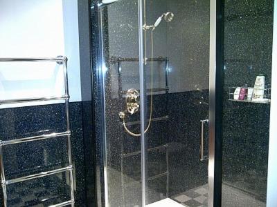 a shower with a glass door in a bathroom at Parliament Square - Royal Mile in Edinburgh