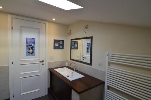 a bathroom with a sink and a mirror at Corte Dei Frati in Affi