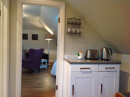 a kitchen with a counter with a microwave on it at Field Cottage B&B in Haywards Heath
