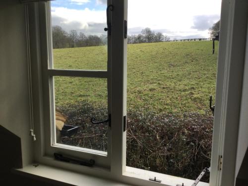 a window with a view of a field at Field Cottage B&B in Haywards Heath