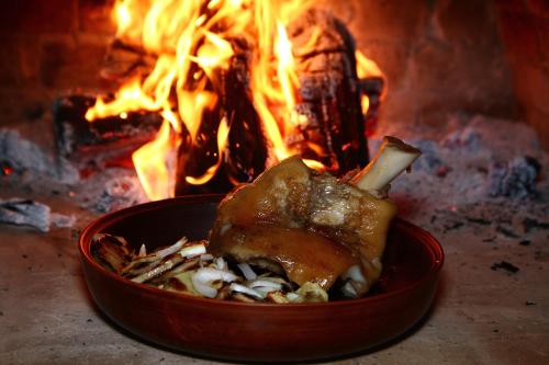 a bowl of food in front of a fire at Seven Stars in Sumy