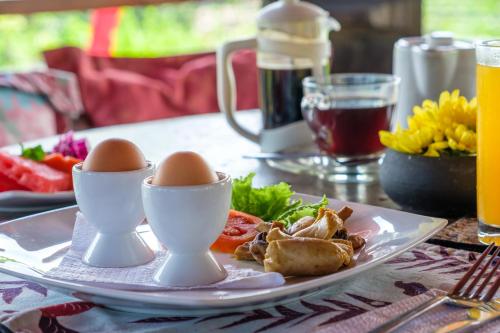 a plate of eggs and vegetables on a table at Kamar Kamar Boutique Hotel in Seminyak