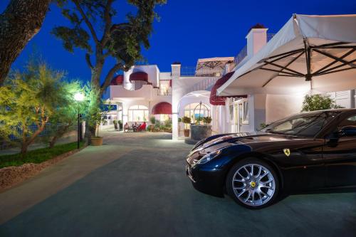 a black car parked in front of a house at Hotel La Madonnina in Ischia