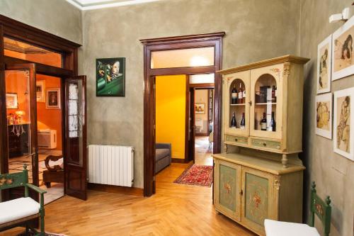 a living room with an old cabinet in a room at Palazzo Melluso LUXURY SUITE in Porto Empedocle