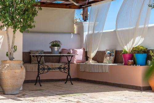 a patio with a table and potted plants at Lorenzo Villas with Private Pool, 200m from the beach, by ZanteWize in Lithakia