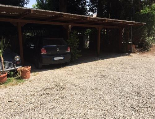 a car parked under a shed with a car parked at Affittacamere Villa Wilson in Rome