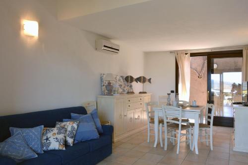 a living room with a blue couch and a table at Casa Bithia in Chia