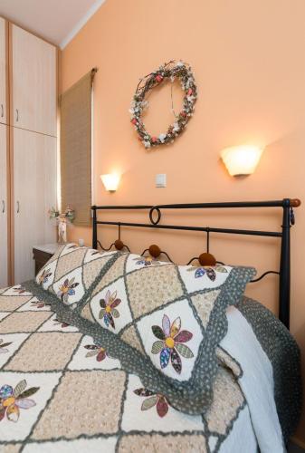 a bedroom with a bed with a wreath on the wall at Lorenzo Villas with Private Pool, 200m from the beach, by ZanteWize in Lithakia