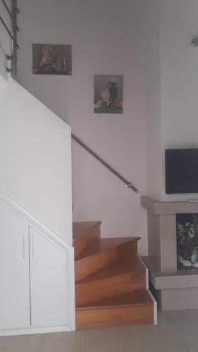 a staircase in a house with a tv on the wall at Mare Beach Apartments in Stavros
