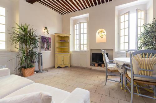 a living room with a table and a dining room at Very charming studio apartment on port in Cannes a short walk to Palais with Aircon and internet 411 in Cannes
