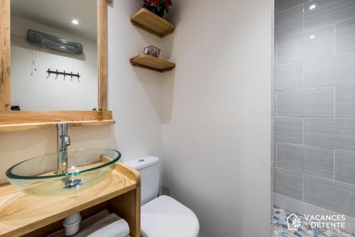 a bathroom with a glass sink and a toilet at Tignes 301 in Tignes