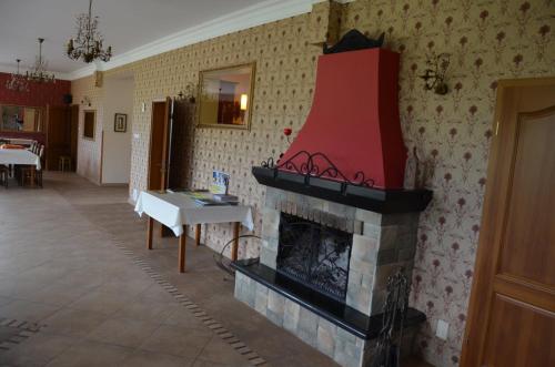 a living room with a fireplace with a red stocking above it at Jaś i Małgosia nad Jeziorem Wigry in Rosochaty Róg