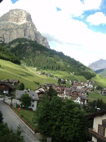 a town in a valley with a mountain in the background at Hotel Borest in Colfosco