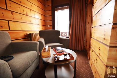 a hotel room with two chairs and a table at L'empreinte D'ifrane in Ifrane