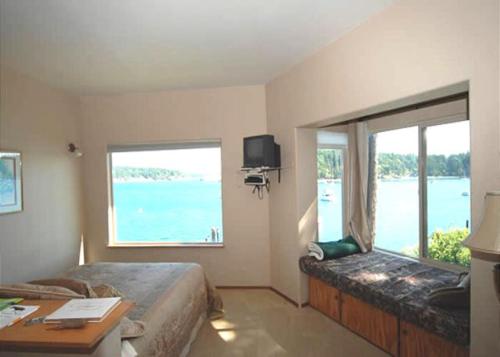 a bedroom with a bed and a large window at Sweet Escape & Summer Dream in Friday Harbor