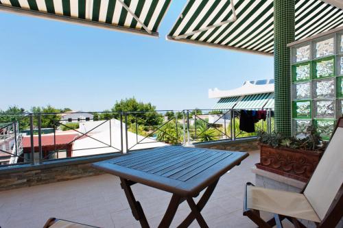 a blue table and a chair on a balcony at Hotel La Tramontana in San Domino
