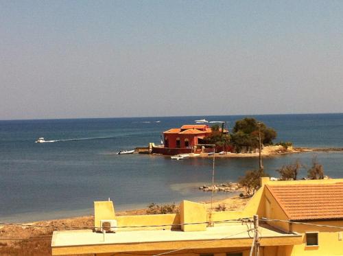 a house on a small island in the water at Casa Marea in Marzamemi