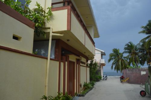 a building with plants on the side of it at Sun Shine View in Maafushi