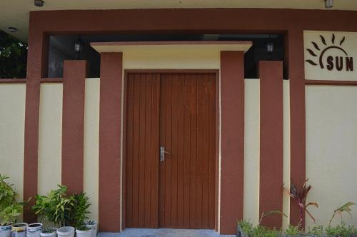 a wooden door on the side of a building at Sun Shine View in Maafushi