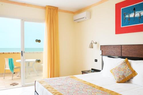 A bed or beds in a room at Royal Horizon Boa Vista