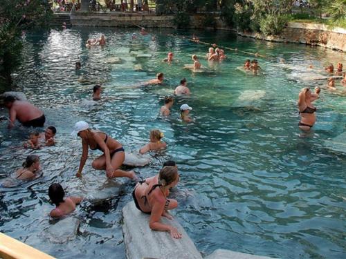 a group of people in a swimming pool at Çavdar Thermal Hotel in Pamukkale