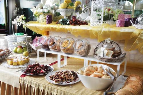 a table filled with different types of bread and pastries at Hotel La Nidiola in Riccione