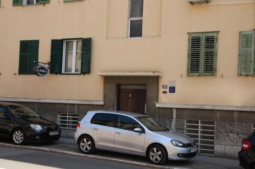 a silver van parked in front of a building at Apartment Simone in Split