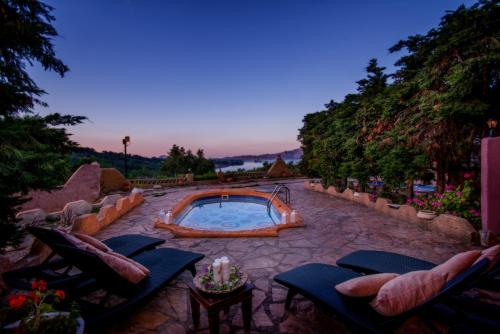 a patio with a swimming pool with chairs and a table at Athenea Villas, Private Pools & Gardens in Keri