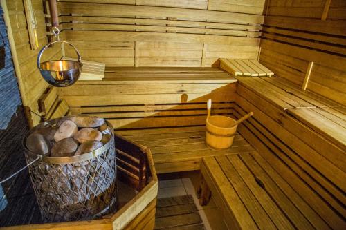 a inside of a sauna with a bucket of logs at Hotel Centrum Harrachov in Harrachov