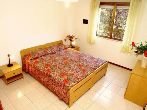 A bed or beds in a room at Lignano Pineta with air conditioning&washing machine