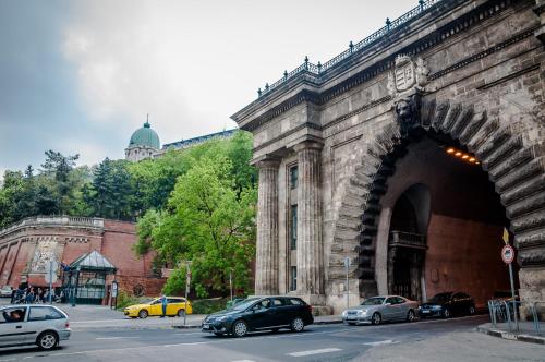 a large stone bridge with cars parked on the street at Castle Suite in Budapest