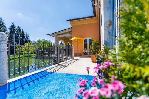 a house with a fence and a swimming pool at Wellness Resort Romantika in Hauzenberg