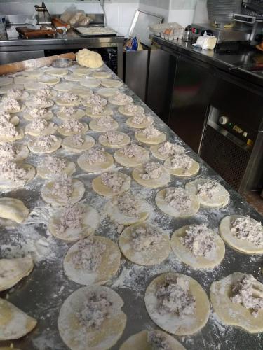 a bunch of uncooked pizzas on a counter in a kitchen at Hotel Casa Nicola in Ischia